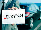 A person holding a Car Leasing plackard.