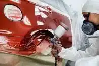 Painter respraying a car.
