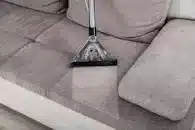 Cleaning a sofa by a carpet and upholstery cleaning company.