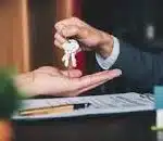 Estate Agents handing over keys to buyer.