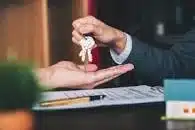 Estate agent handing over keys to the house they have sold.
