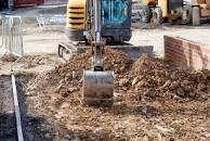 A digger working on groundwork and surfacing.