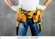 A handyperson wearing a tool belt
