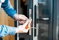 Locksmith changing the locks on a door.