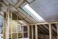 A loft conversion being turned in to a room.