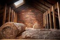 A loft space having insilation laid to help keep the house warm.