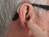 A person having their ear checked at an ear clinic.