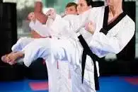 2 martial arts trainers sparring in their martial arts school.
