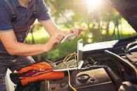 A mobile mechanic servicing a car.
