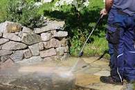 Pressure washing stone to make it clean again.