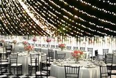 Wedding Venue with lights and table and chairs.