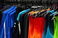 Fitness clothing hanging up in a store.