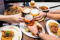 People eating food and having a drink.