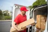 Goods Delivery driver delivering parcels from his van.