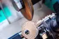 A key being cut by a key cutter.