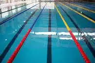 A swimming pool being used by the public in a leisure centre.