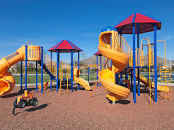 Play area for children full of play equipment.