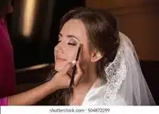 A bride having her weedding hair & make up done.