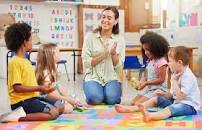 A teacher in a play group or a pre school teaching children.