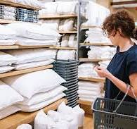 A person in a homeware household store buying products.