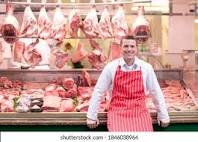 Butcher showing all the meat for sale.