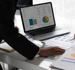 Business Consultants showing graphs and reports.