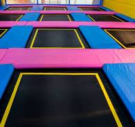 row of trampolines in a trampoline park.