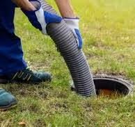 A person emptying a cesspit and septic tank.