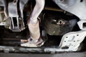 Drain the old lubricant from the engine through the drain plug. Changing the oil in a car engine.