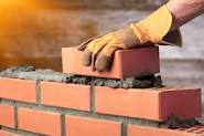 Brickwork bricklayers laying bricks to build houses.