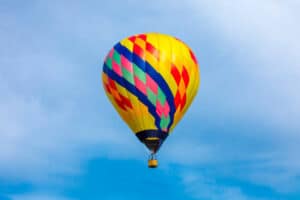 A beautiful hot air balloon floating in the sky on a lovely summer evening.